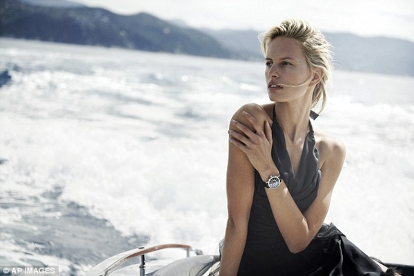 Boating beauty: Karolina dazzles on the back of a speed boat in a deep blue halter neck gown 